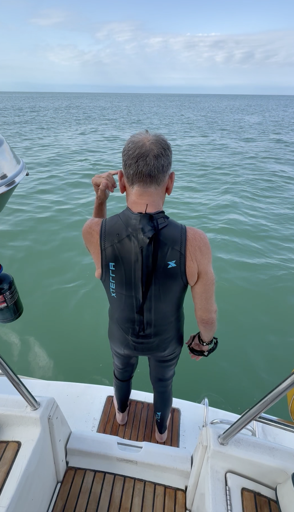 Guest jumping into warm Gulf waters from Northern Lights